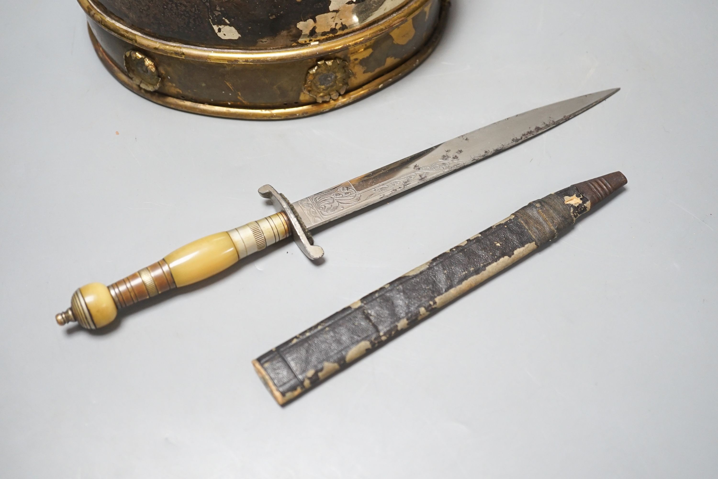 A Middle-Eastern silvered metal and brass helmet and a dagger in sheath